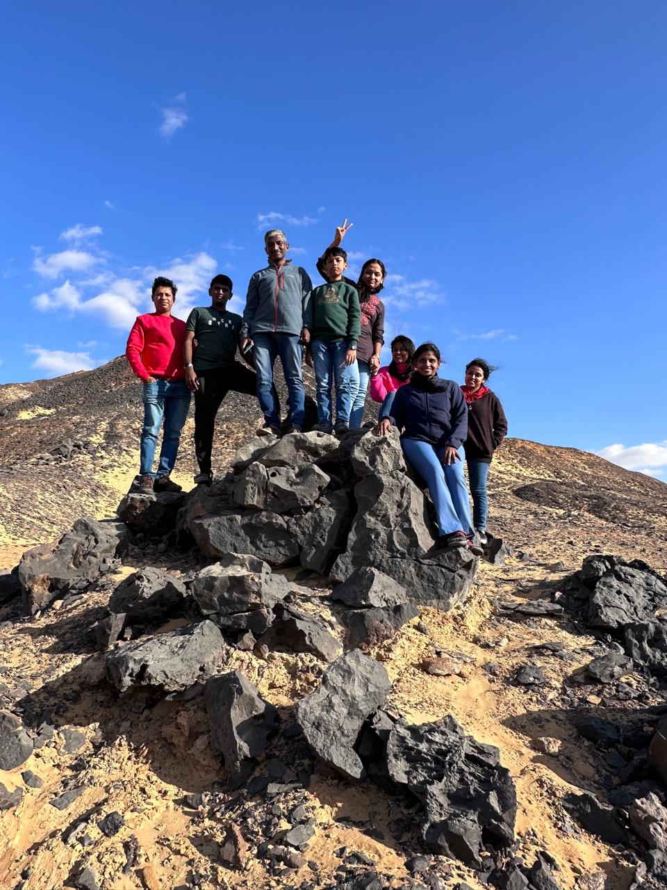 A group of travellers standing together on a rocky hillside