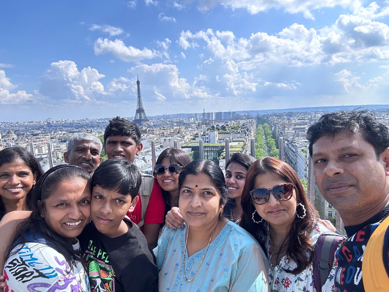 Travellers taking a group selfie above a city skyline